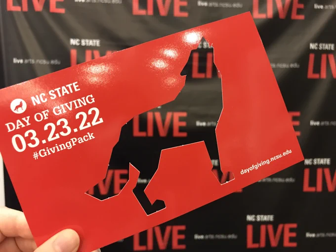  NC State Wolf cutout in front of NC State LIVE step and repeat backdrop.