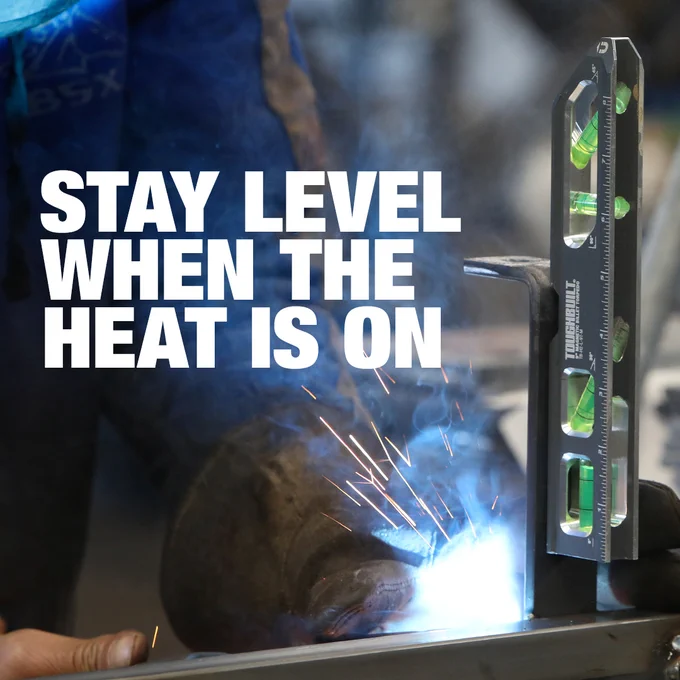 Welder using the Toughbuilt 9-in Magnetic Billet Torpedo Level standing on steel pipe mid weld. The text says Stay Level When The Heat Is On