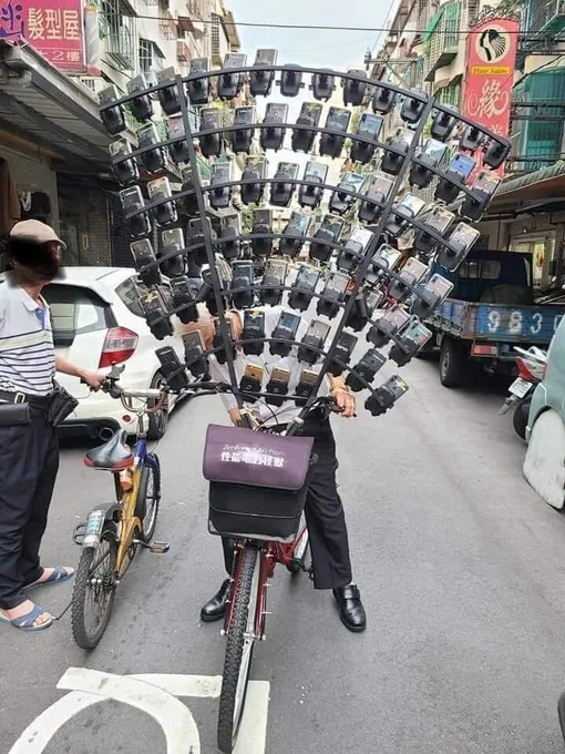 Pokemon Go hunter with lots of phones attached to bicycle