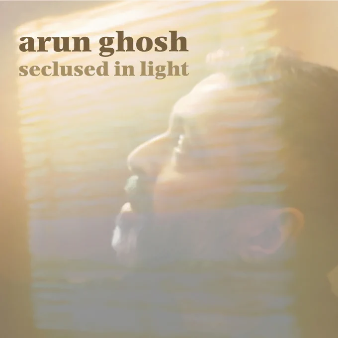 Arun Ghosh Seclused in Light album cover. A close-up side profile of the head of clarinettist Arun Ghosh bathed in light streaming through in the form of a window blind's shadow.