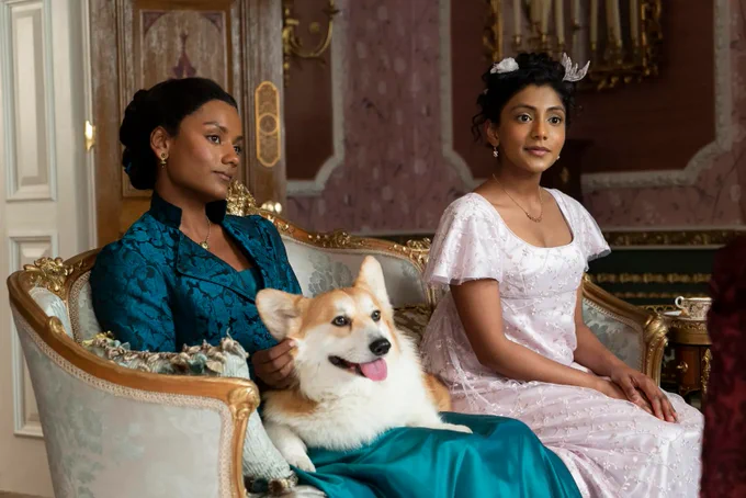Newton the corgi with the Sharma sisters