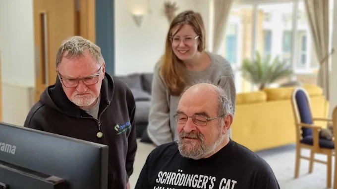 Paul, Chris and Beverley looking at Chris' work on Chris' monitor