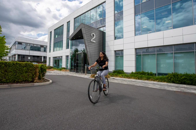 Cyclist riding outside an office building