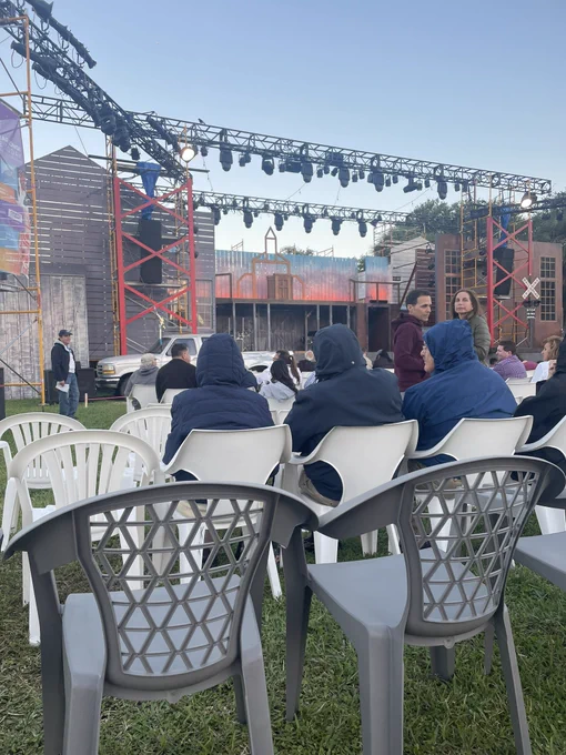 View of the stage. Rows of chairs between stage and lawn seats