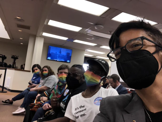 Advocates in masks gathered in statehouse room