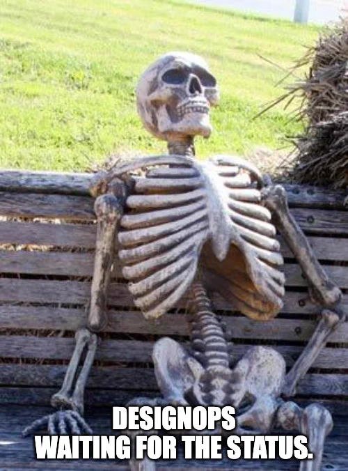 DesignOps waiting for the status - skeleton sitting on bench.