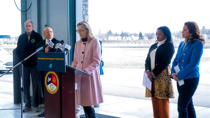 Kimberly Roberson of the Mott Foundation stands at a podium at a press conference.