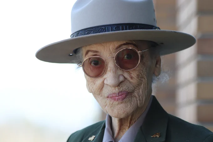 Portrait of Ranger Betty Reid Soskin in front of visitor center building. 