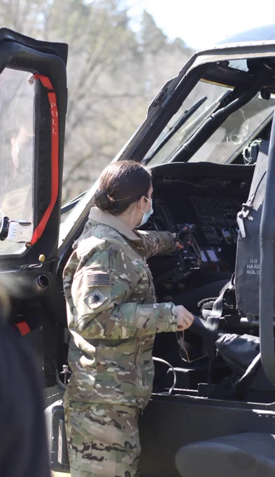Airman explains the controls in a Blackhawk helicopter.