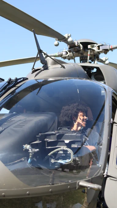 Student getting her photo in the cockpit.
