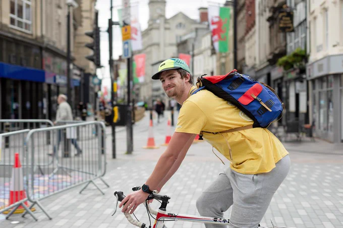 Man cycling in town centre