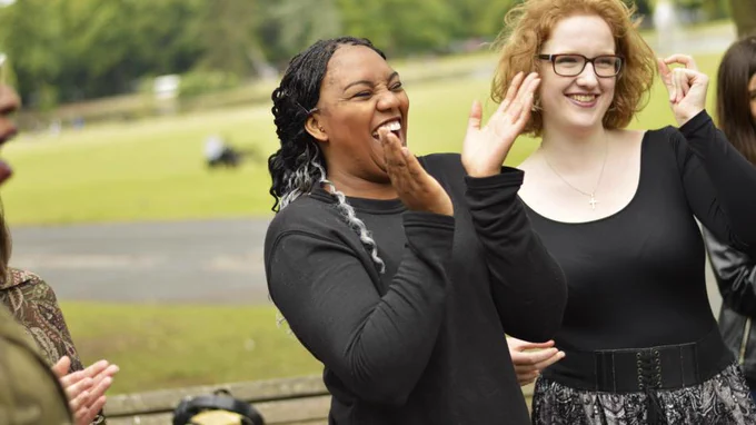2 people clapping and smiling