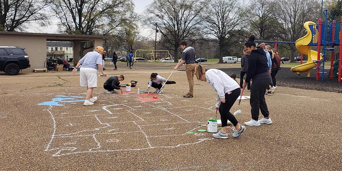 VCU School of Education students paint a map of the U.S. at the SOE Day of Service to Support Fox Elementary School on April 5, 2022.