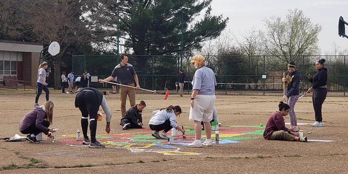 VCU School of Education Health and Physical Education students paint a map of the U.S. at the SOE Day of Service to Support Fox Elementary School on April 5, 2022.