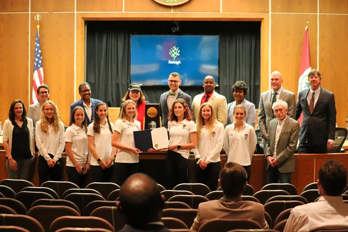 The Raleigh City Council posing with the 2021 NCAA Champion NC State women's cross country team 