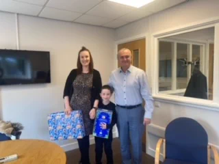 Noah Receiving his well deserved prize and easter egg from Anthony Carlyle MD IKO Group