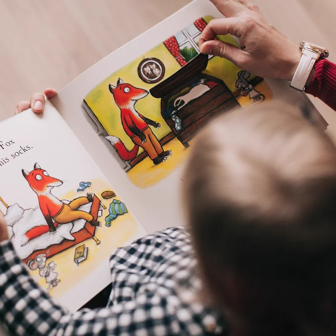 child reading a board book