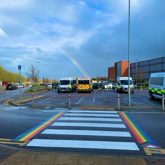 An image of a rainbow behind our new rainbow crossing