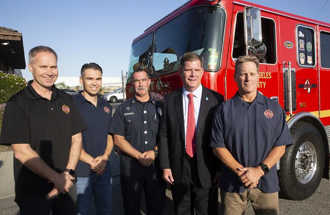 Secretary Walsh stands with a group of firefighters in LA.
