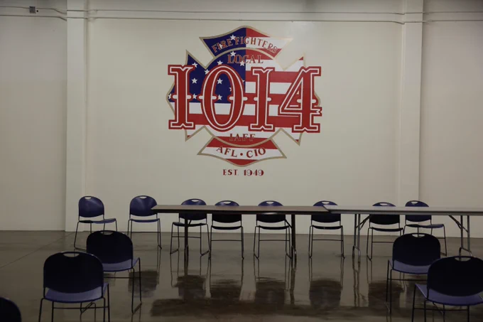 A local IAFF 1014 logo is above a table surrounded by chairs.