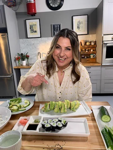 Mary poses in the kitchen with some homemade sushi.