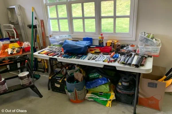 hardware and garden tools arranged on table in garage showing categorizing portion of estate clearing process