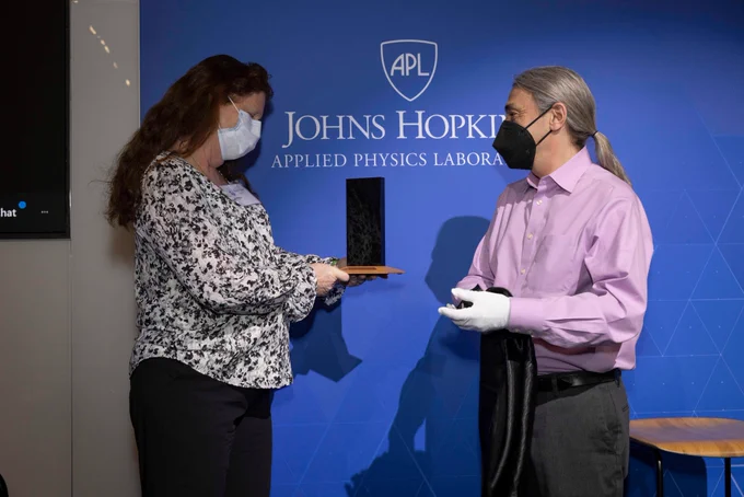 Karla Clark receiving the Monolith Award from Bob Pappalardo