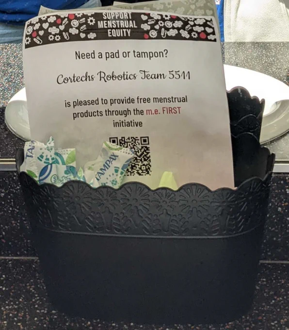 Basket containing flyer and menstrual products
