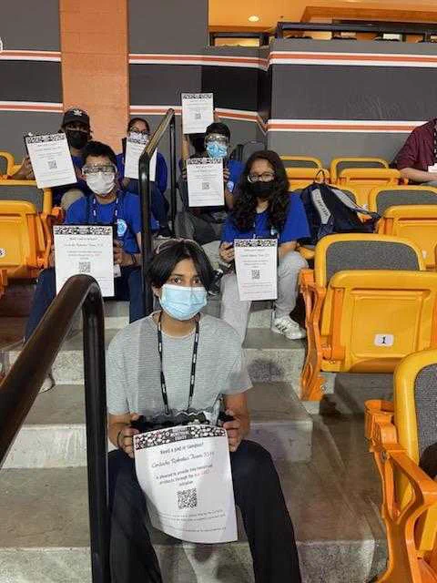 Picture of members of Cortechs Robotics holding m.e. FIRST Ambassador flyers