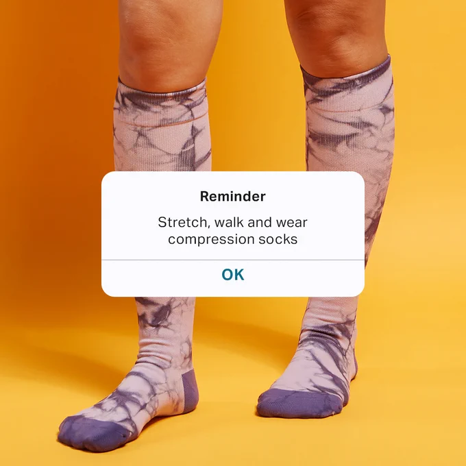 Reminder: stretch, walk and wear compression socks to feel your best. Picture features Comrad Socks purple tie dye knee high compression socks.