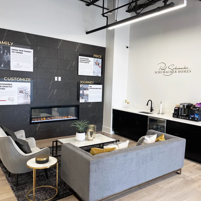 Waiting room with grey loveseat and armchair.