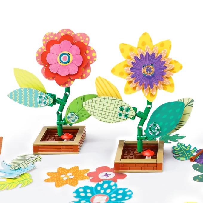 Two colorful flowers build of paper and bricks