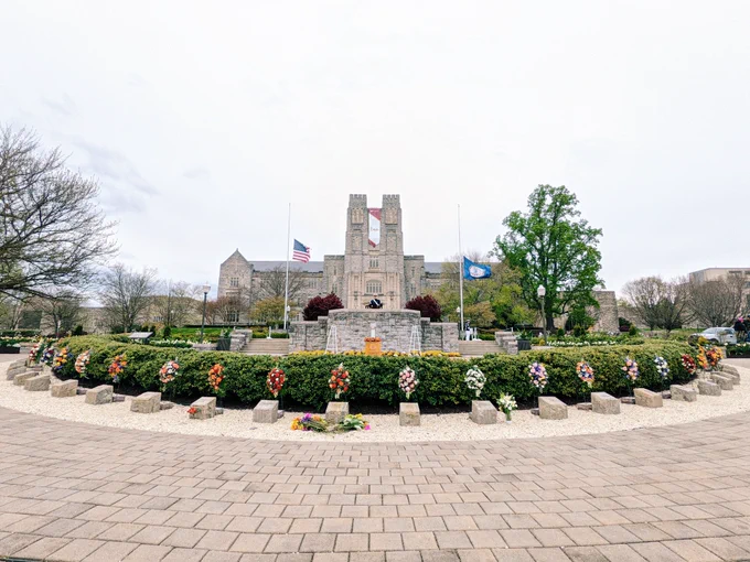 Flowers are placed at the April 16 Memorial in front of Burruss Hall. 