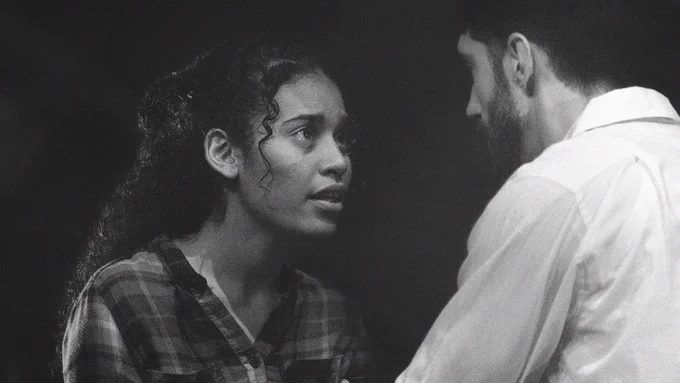 Character Arjola in Toka (played by Kat Khan) is passionately convincing her brother of something, she looks sincere and concerned.