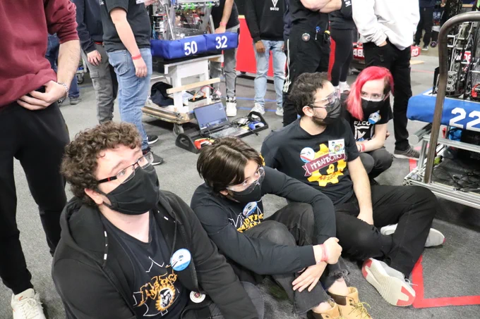 Co-driver, human player and technician sitting with an alliance member.