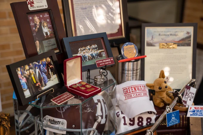 Aggie Muster Reflections Display for Kathryn Greenwade '88 surrounded with photos, Texas A&M memorabilia, and letters.
