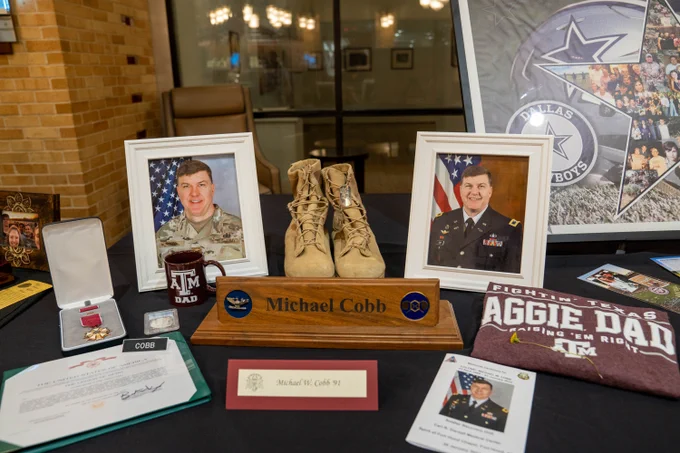 Aggie Muster Reflections Display for Michael Cobb '91 surrounded by his photos, Aggie Dad memorabilia, and military awards.