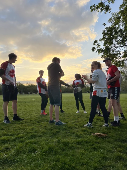 Basemakers team talk with sunset in the background