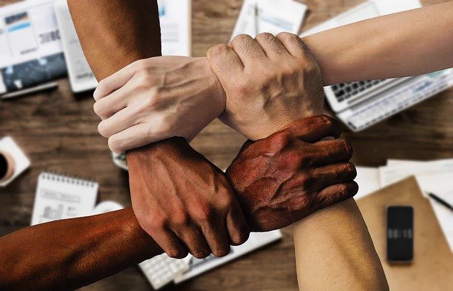 Group work does work, like hands joined together if the activity is created well. Image by Tumisu, from Pixabay.com