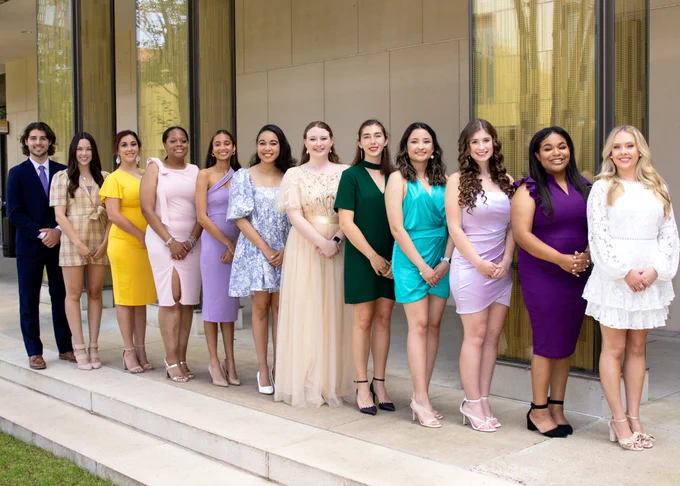 The Tiger Twelve pose for a photo in the Business Education Complex quad.