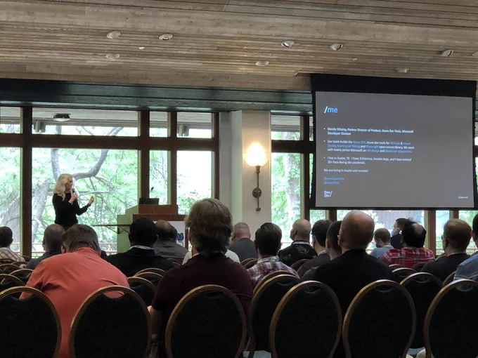 Mandy Whaley speaking onstage with a slide introducing herself (more text than i can transcribe, i'll link to the slide deck later if i find it shared)