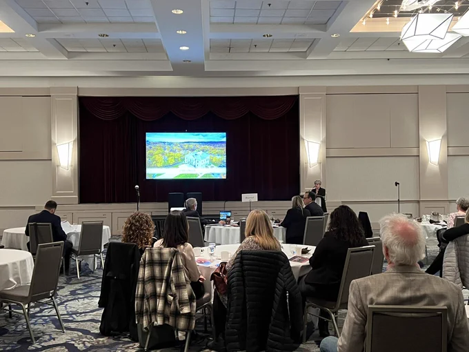 Looking out from behind a crowd to a presentation from Destination St. John’s.