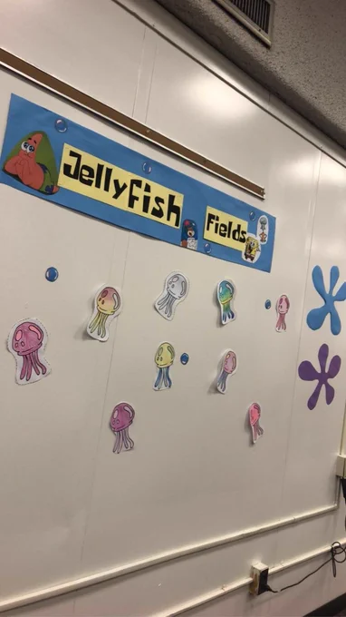 A sign reading Jellyfish Fields with paper jellyfish colored by students