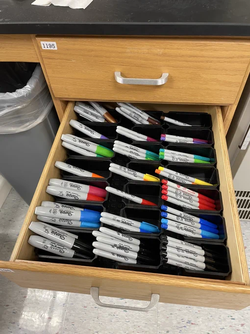 Photo of multiple pens organized by color and size.