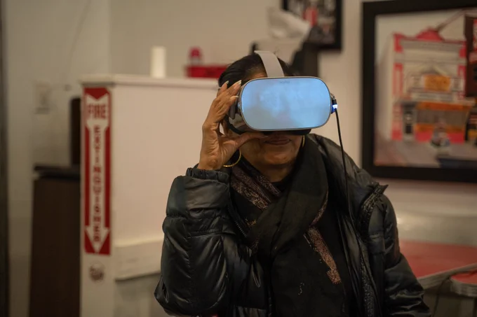 Woman with VR headset experiencing the Black Broadway on U virtual tour experience.