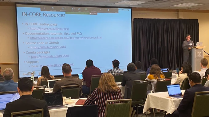 Jong Lee gives a talk at Colorado State University in a large conference room full of people. The screen shows a list of URLs for more information, which will be provided downthread.