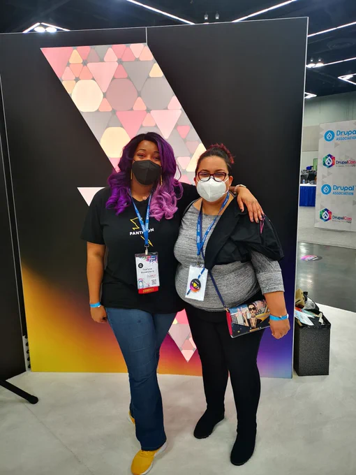 Tearyne and Dharizza standing at Drupal Con Portland 2022 in Pantheon booth. 