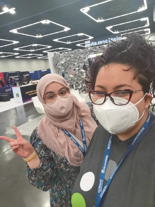 Fatima and Dharizza at the expo hall in Drupal Con Portland 2022. 