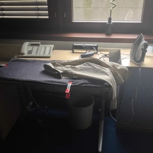 Ironing shirt in the openSAP studio before recording the first HANA course. Makeshift ironing board using a towel, lighting clips, and someone's desk. 
