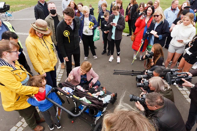 First Minister Nicola Sturgeon being photographed beside children in a buggy